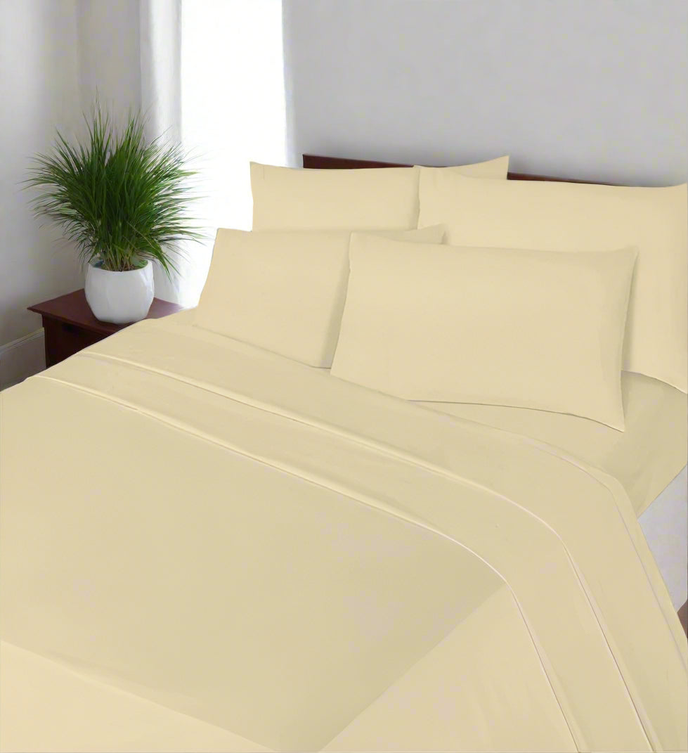 Blue bed sheet set with matching pillows on a bed in a bedroom setting.