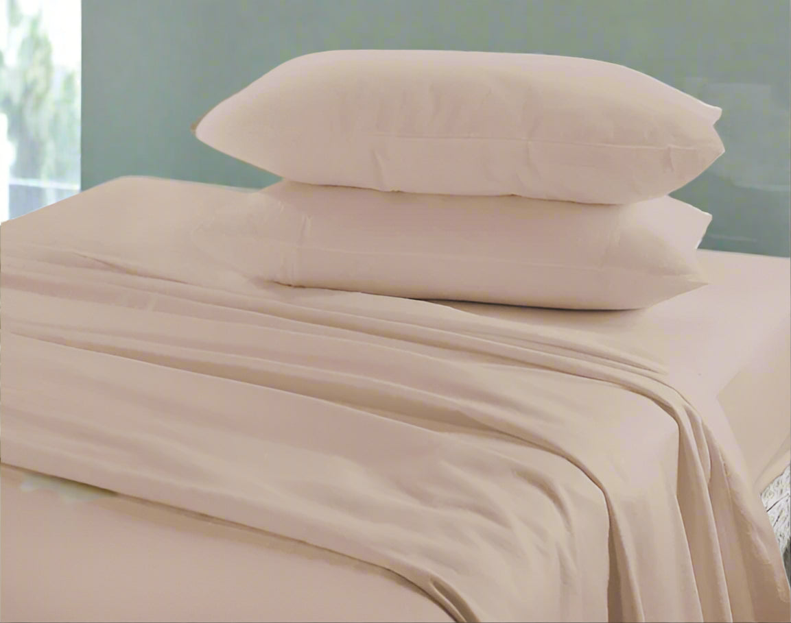 Beige bed sheets and pillows on a bed with a neutral background