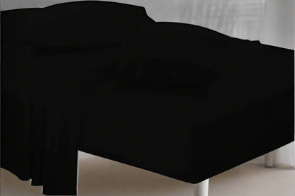 Black bed sheet on a bed with a neutral background
