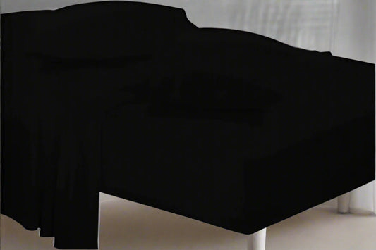 Black bed sheet on a bed with a neutral background
