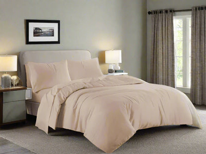 Beige bedding set on a bed in a bedroom with gray walls and wooden floors.