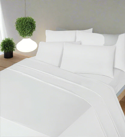 White bedding set on a bed in a bedroom